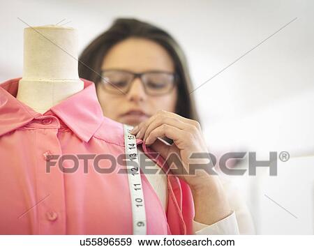 Fashion designer measuring garment in fashion design studio, close up View Large Photo Image Stock Photo - Fashion designer measuring garment in fashion design studio, close up. Fotosearch