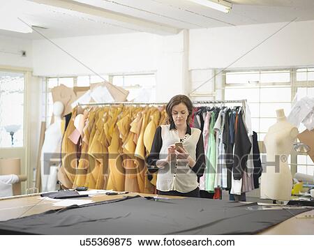 Fashion designer using mobile phone in fashion design studio View Large Photo Image Stock Photography - Fashion designer using mobile phone in fashion design studio. Fotosearch