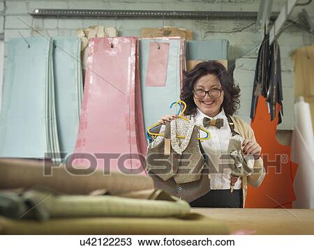 Fashion designer with childrens wear in clothing factory, portrait View Large Photo Image Stock Image - Fashion designer with childrens wear in clothing factory, portrait. Fotosearch