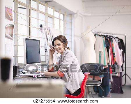 Fashion designer working at computer in fashion design studio, portrait View Large Photo Image Picture - Fashion designer working at computer in fashion design studio, portrait. Fotosearch