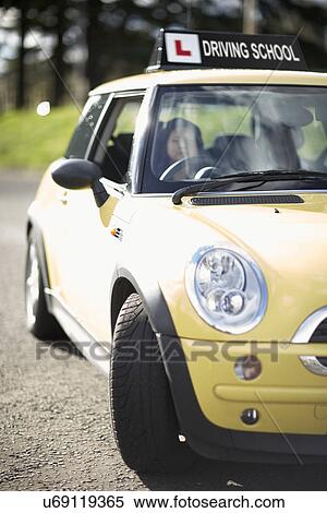 Stock Photography - Female learner driver behind wheel of car. Fotosearch