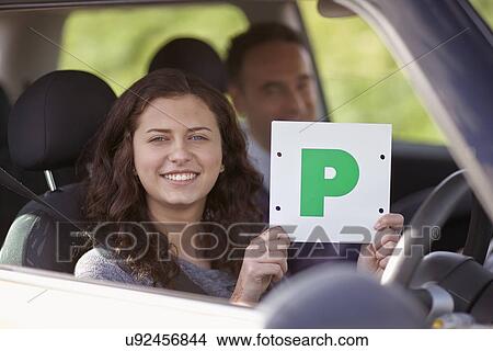 Female learner driver holding Passed Plate View Large Photo Image Picture - Female learner driver holding Passed Plate. Fotosearch
