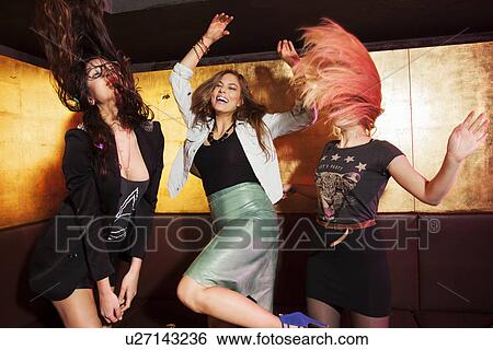 Four female friends dancing in nightclub View Large Photo Image Stock Photograph - Four female friends dancing in nightclub. Fotosearch