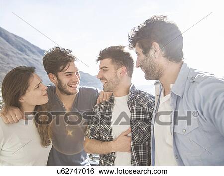Four friends on mountainside View Large Photo Image Stock Photograph - Four friends on mountainside. Fotosearch