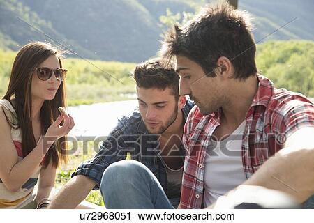 Friends sitting having picnic View Large Photo Image Stock Image - Friends sitting having picnic. Fotosearch