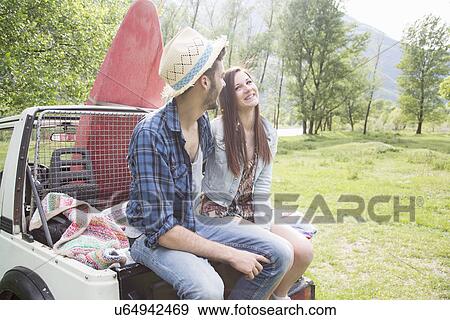 Friends sitting on back of off road vehicle View Large Photo Image Stock Photo - Friends sitting on back of off road vehicle. Fotosearch