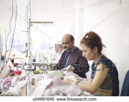 Garment workers in clothing factory View Large Photo Image Stock Image - Garment workers in clothing factory. Fotosearch