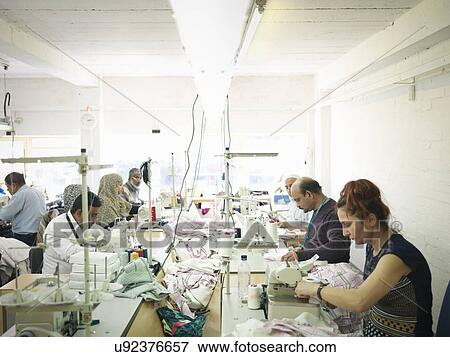 Garment workers in clothing factory View Large Photo Image Stock Photo - Garment workers in clothing factory. Fotosearch