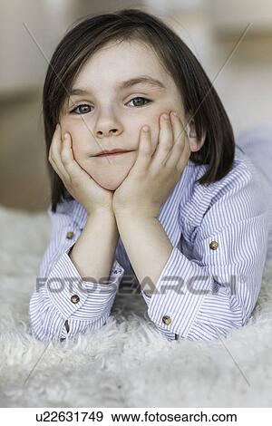 Girl wearing striped shirt with hands on chin View Large Photo Image Stock Photo - Girl wearing striped shirt with hands on chin. Fotosearch