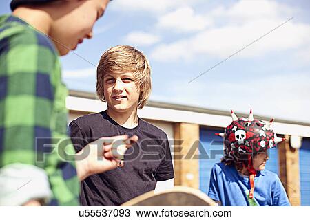Stock Image - Group of boys talking. Fotosearch
