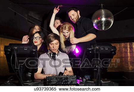 Group of friends watching DJ in nightclub View Large Photo Image Stock Photography - Group of friends watching DJ in nightclub. Fotosearch