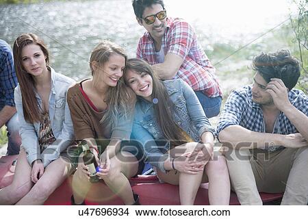 Group of six friends sitting on canoe View Large Photo Image Picture - Group of six friends sitting on canoe. Fotosearch