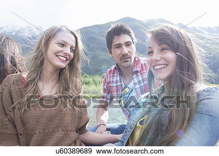 Group of three young adult friends laughing, Piemonte, Italy View Large Photo Image Stock Photo - Group of three young adult friends laughing, Piemonte, Italy. Fotosearch