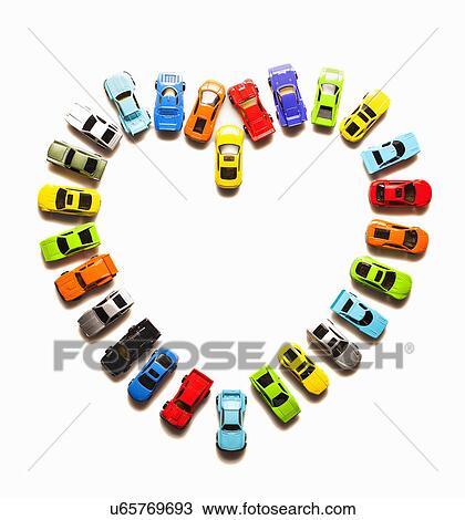 Stock Image - Heart-shaped pattern of toy cars. Fotosearch