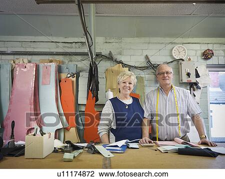 Stock Image - Husband and wife owner of clothing factory, portrait. Fotosearch