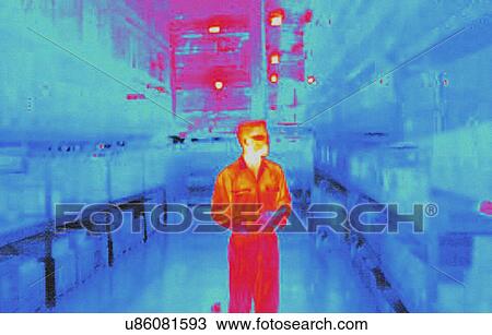 Stock Image - Infra red heat image of warehouse worker in factory. Fotosearch