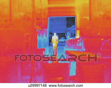 Stock Photo - Infra red heat image of worker and heat loss from loading doors in factory. Fotosearch