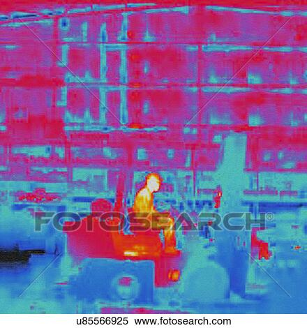 Stock Photography - Infra red heat image of worker in fork lift truck in factory. Fotosearch