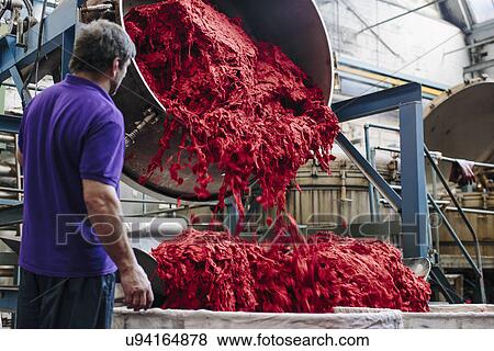 Stock Photo - Male factory worker dyeing wool in woollen mill. Fotosearch