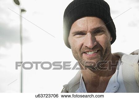 Stock Photograph - Man with black beanie hat. Fotosearch