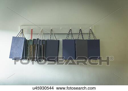Picture - Material sample books hanging in clothing factory. Fotosearch