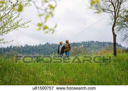 Mature woman and teenage daughter strolling in fields View Large Photo Image Stock Photo - Mature woman and teenage daughter strolling in fields. Fotosearch