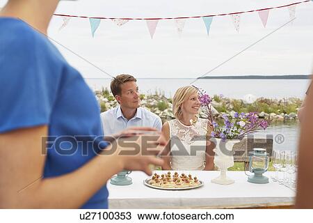 Mid adult couple and friends at wedding reception View Large Photo Image Stock Image - Mid adult couple and friends at wedding reception. Fotosearch