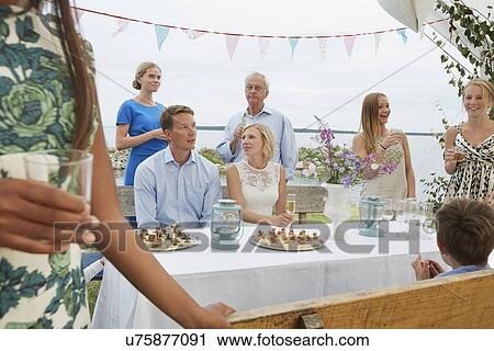 Mid adult couple at wedding reception with group of friends View Large Photo Image Stock Image - Mid adult couple at wedding reception with group of friends. Fotosearch