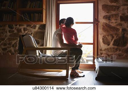 Mid adult man and daughter looking out of window View Large Photo Image Picture - Mid adult man and daughter looking out of window. Fotosearch