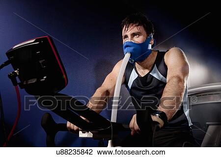 Mid adult man in face mask on gym exercise cycle in altitude centre View Large Photo Image Stock Image - Mid adult man in face mask on gym exercise cycle in altitude centre. Fotosearch