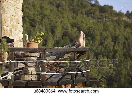 Mid adult man relaxing on balcony, Villahermosa del Rio, Castellon, Spain View Large Photo Image Picture - Mid adult man relaxing on balcony, Villahermosa del Rio, Castellon, Spain. Fotosearch