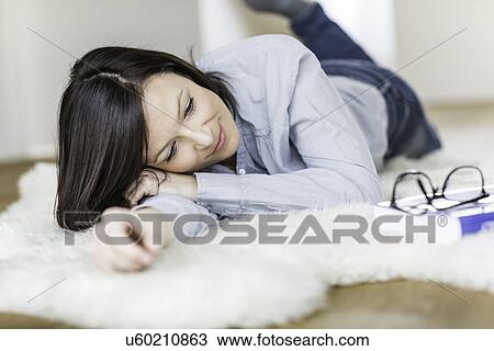 Mid adult woman lying on fur rug View Large Photo Image Stock Image - Mid adult woman lying on fur rug. Fotosearch