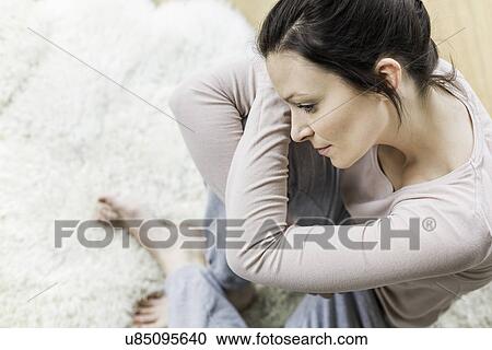 Mid adult woman sitting on floor, high angle View Large Photo Image Stock Image - Mid adult woman sitting on floor, high angle. Fotosearch