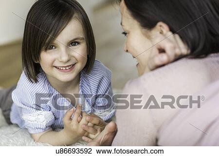 Stock Image - Mother and daughter smiling. Fotosearch