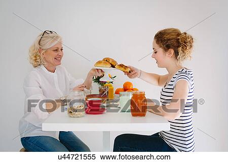 Mother and teenage daughter sharing breakfast View Large Photo Image Stock Photography - Mother and teenage daughter sharing breakfast. Fotosearch