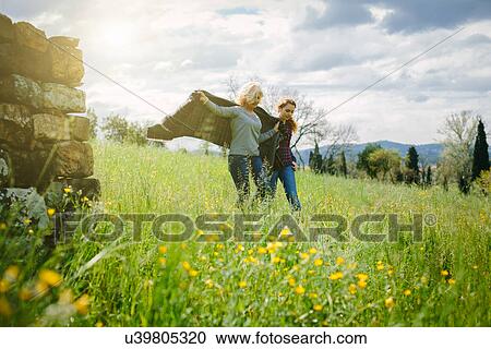 Mother and teenage daughter strolling with blanket View Large Photo Image Stock Image - Mother and teenage daughter strolling with blanket. Fotosearch