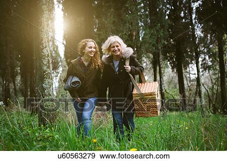 Mother and teenage daughter strolling with picnic basket View Large Photo Image Stock Photo - Mother and teenage daughter strolling with picnic basket. Fotosearch