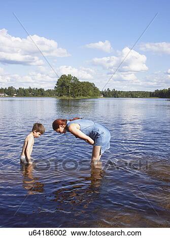 Mother and young son in searching in lake, Gavle, Sweden View Large Photo Image Stock Image - Mother and young son in searching in lake, Gavle, Sweden. Fotosearch