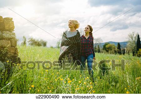 Mother wrapped in blanket strolling with teenage daughter View Large Photo Image Stock Image - Mother wrapped in blanket strolling with teenage daughter. Fotosearch