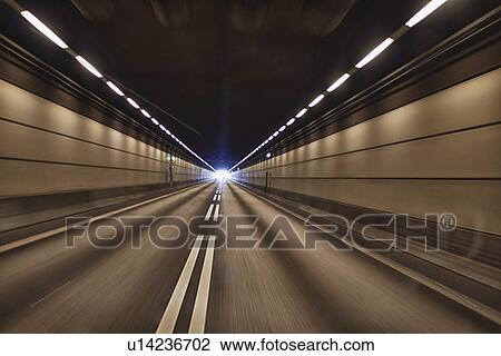 Stock Image - Motion blur view of road tunnel. Fotosearch