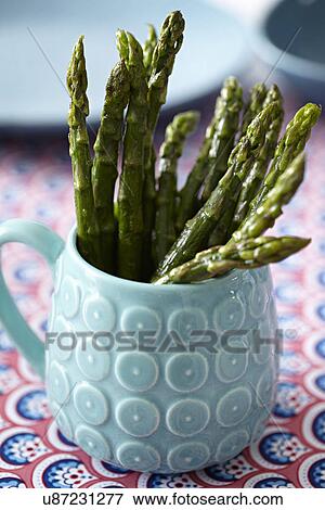 Mug of asparagus tips View Large Photo Image Stock Photo - Mug of asparagus tips. Fotosearch