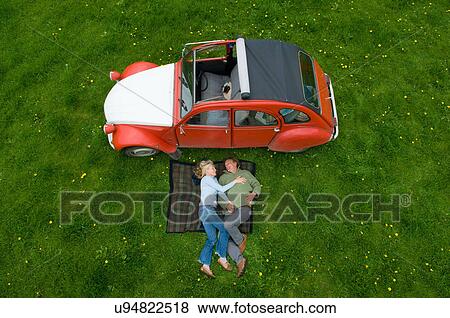 Overhead view of mature couple relaxing on picnic blanket View Large Photo Image Stock Photo - Overhead view of mature couple relaxing on picnic blanket. Fotosearch