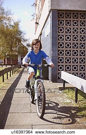 Portrait of boy cycling View Large Photo Image Picture - Portrait of boy cycling. Fotosearch