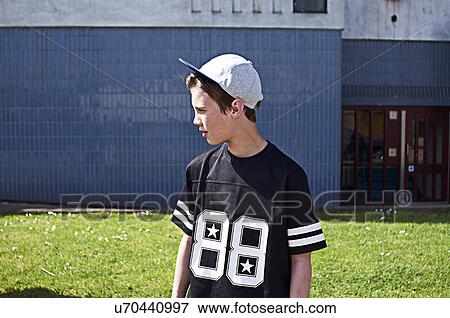 Portrait of boy wearing baseball cap looking away View Large Photo Image Stock Photo - Portrait of boy wearing baseball cap looking away. Fotosearch