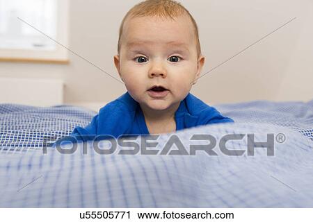Portrait of contented 7 month old baby girl looking at camera View Large Photo Image Stock Image - Portrait of contented 7 month old baby girl looking at camera. Fotosearch
