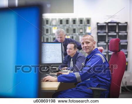 Stock Photo - Portrait of engineer in meeting in nuclear power station. Fotosearch