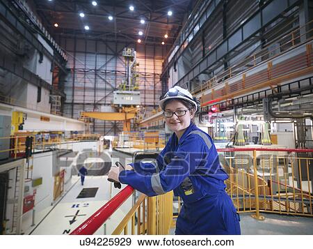 Stock Photo - Portrait of female engineer in reactor hall in nuclear power station. Fotosearch