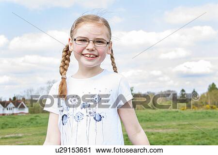 Portrait of girl with blond plaits View Large Photo Image Stock Image - Portrait of girl with blond plaits. Fotosearch