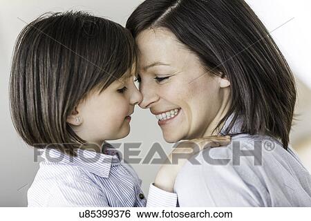 Stock Photograph - Portrait of mother and daughter face to face. Fotosearch