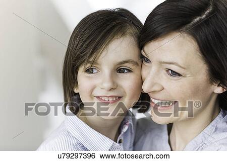 Stock Photograph - Portrait of mother and daughter smiling. Fotosearch